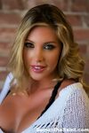 Beautiful blonde Samantha Saint shows off her long legs and 