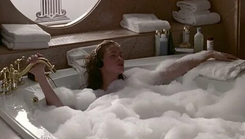 Actor Julia Roberts relaxes in a bathtub filled with bubbles. 