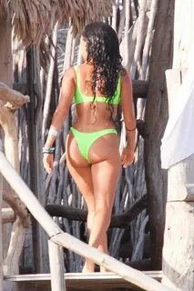 Vanessa Morgan in a tight green bikini showing nice cleavage