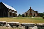 Texas Hill Country style stone ranch house and party barn on