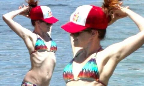 Alyson Hannigan reveals sharp rib cage at beach with husband