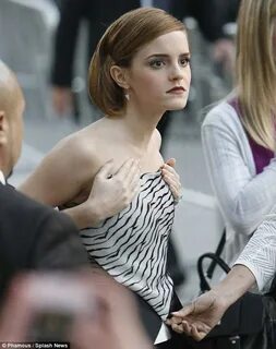 Emma Watson struggles with low-cut corset top as she takes c