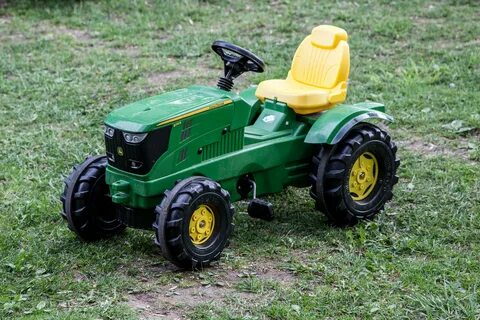 Toy tractor on green grass free image download