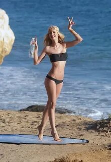 Kat Torres wearing tiny black strapless bikini at the beach 
