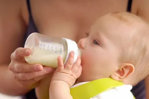 Baby Boy Drinking Milk from the Bottle Isolated Stock Photo 