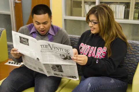 students reading newspaper - EGMN Corporation