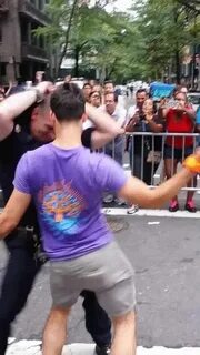 Cop makes gay man put hands in the air on Pride Day - GIF on