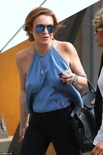Lindsay Lohan braless in halter-neck top for lunch date in M