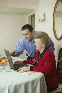 Son Helping Mom With Laptop Фотография, картинки, изображения и сток-фотография 