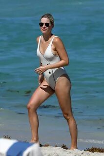 Claire Holt In a white one-piece swimsuit during a beach day
