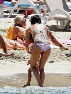Lena Headey goes barefoot in a White Bikini on holiday at Ib
