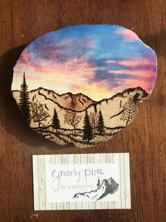 Pyrography. Wood burned mountain scene. Sunset sky. Wood bur