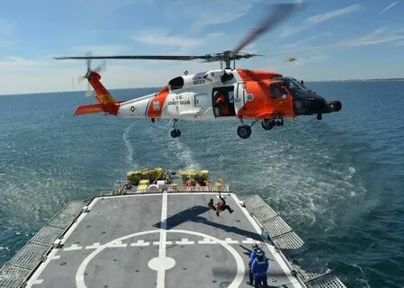 A Coast Guard Air Station Cape Cod helicopter crew works wit
