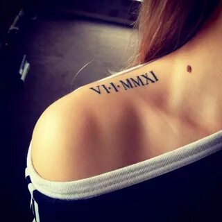 Top of the shoulder tattoo of a date in roman numerals