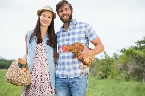 Happy Farmers Holding Chicken and Eggs Stock Image - Image o