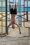 Man Hanging Upside Down at Kids Playground Stock Photo - Ima