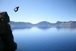 person jump off in a cliff photography #person jump off #pho