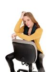A Serious Looking Woman Sitting Backwards on Office Chair St