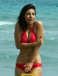 Roxanne Pallett shows cleavage in red bikini on the beach