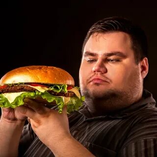 Fat man eating fast food hamberger. Breakfast for overweight