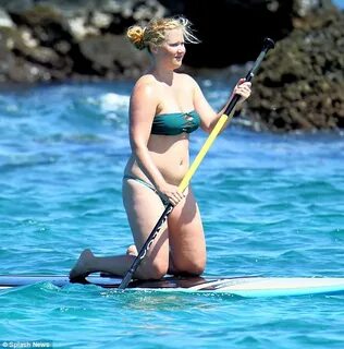 Amy Schumer shows off her bikini body in a green suit while 