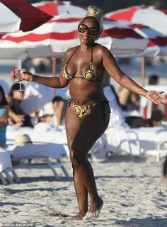 Mary J. Blige flashes rock hard abs in a tiny bikini during 