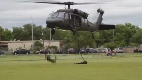 Army Blackhawk helicopter doing a fast roping demonstration 