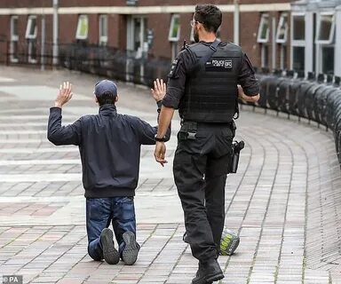 Dramatic moment armed police screaming 'get down!' arrest ma