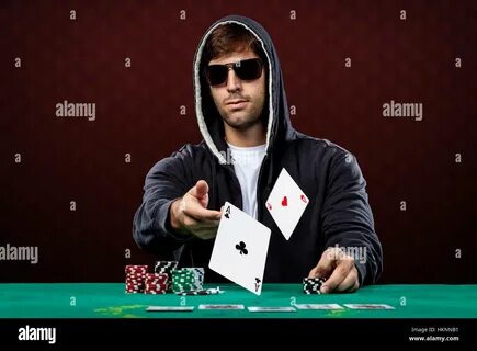 Poker player, on a red background, throwing two ace cards Stock Photo - Ala...