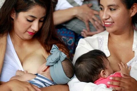 Mothers nurse their children to mark the World Breastfeeding Week to promot