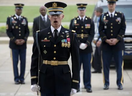 A U.S. Army captain positions a military honor guard to welc