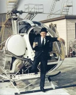 Frank Sinatra descends from a helicopter drink in hand. So h