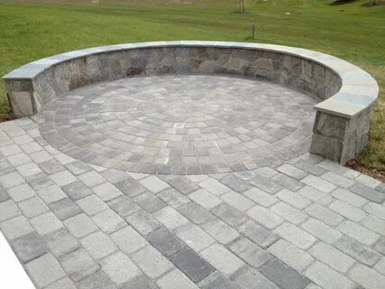 A beautiful Paver Patio with a Stone Seating/Border Wall on 