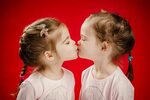 Sisters Give Each Other a Kiss Stock Photo - Image of cute, 