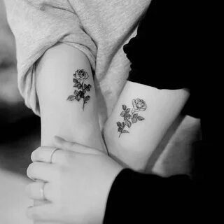 Matching rose tattoos.
