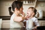 Licking of Whipping Cream - Mother with Daughter Stock Image