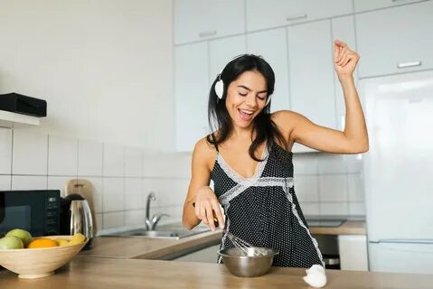 Asian girl dancing with kitchen tools