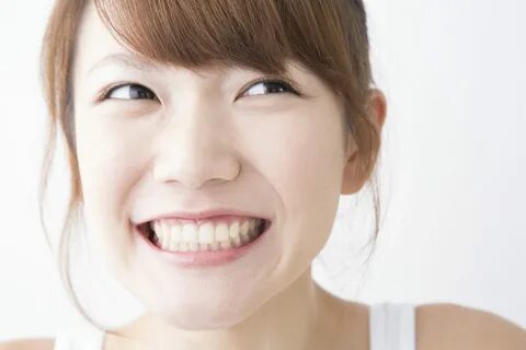 Japanese girls cover their teeth
