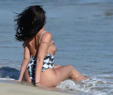 Hayley Fanshaw slips from her white printed thong swimsuit a