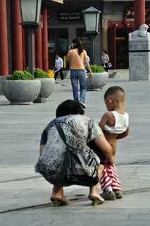 Comfort stop Boy takes a pee in Beijing street. Louis Allen 