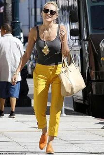 Sharon Stone shows off slim frame in bright yellow skinny tr