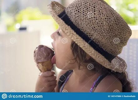 Girl Licking a Chocolate Ice Cream at Summer Stock Photo - I