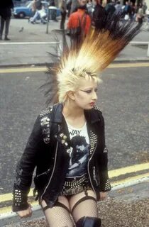 A punk girl with a large mohican, leather jacket and suspenders, UK.