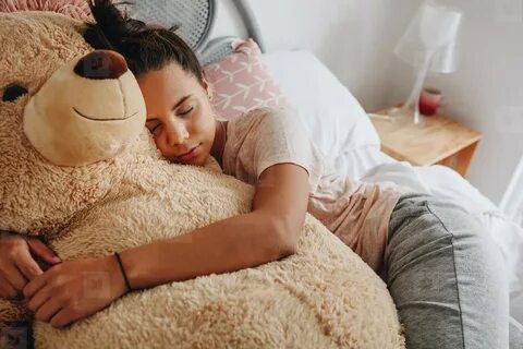 Girl sleeping on bed holding a teddy bear (159827) - YouWork