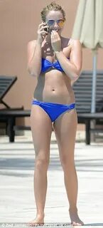 Lydia Bright suns herself around Marbella pool in blue bande