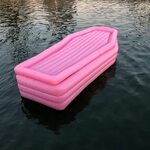 bury yourself this summer in this pink coffin float by pom p