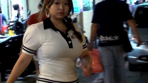 Asian chick bouncing boob on video arcade