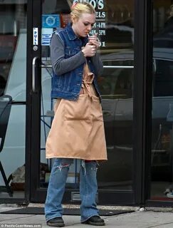 Dakota Fanning slips on an apron to work in a bagel shop for