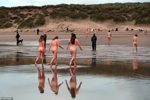 Naked ambition: Record 600 people strip off for a dip in the