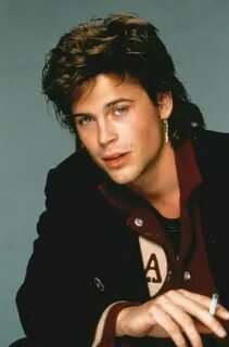 Rob Lowe sporting a fashionable mullet and earring back in t